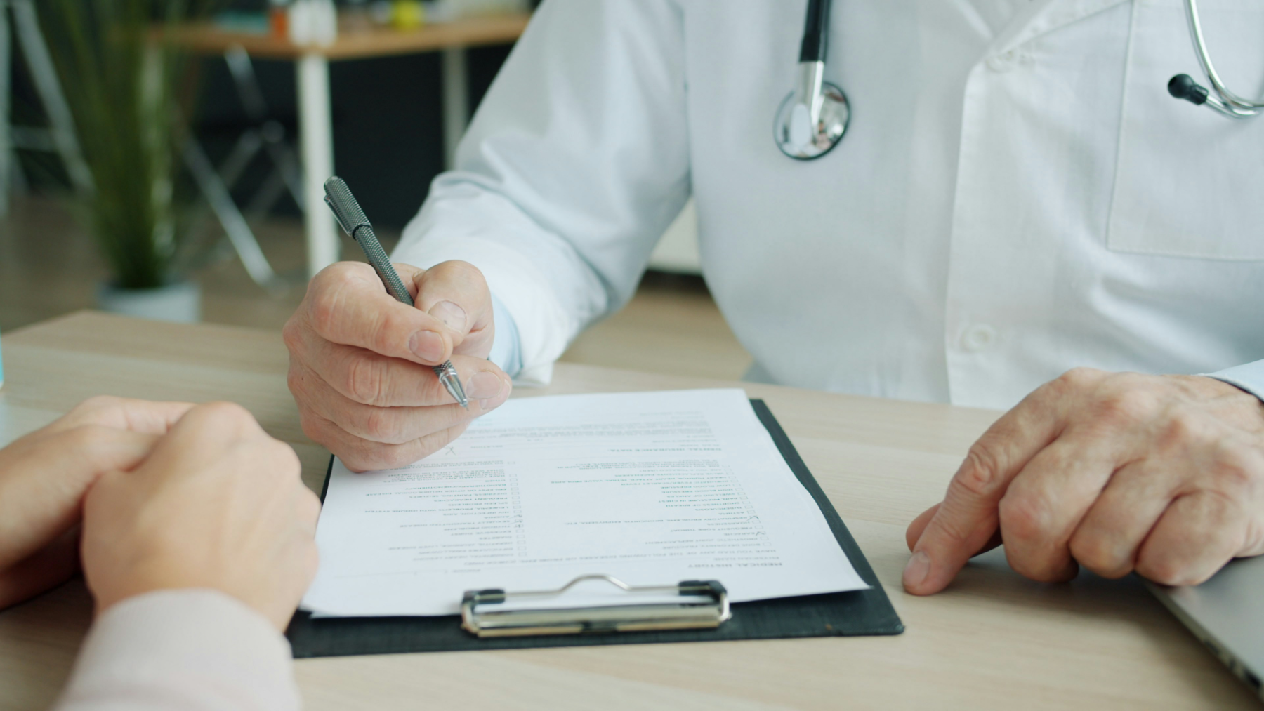 A doctor and a patient reviewing a document together
